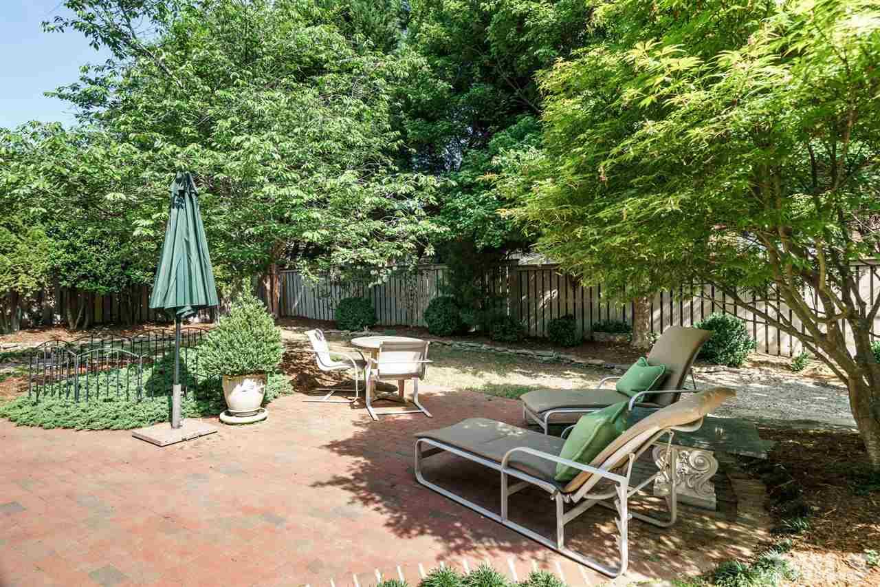 1820 Torrington Street Raleigh, NC 27615 - Photo 25 of 25 a view of backyard with table and chairs and a large tree