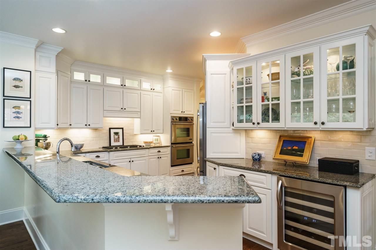 1820 Torrington Street Raleigh, NC 27615 - Photo 8 of 25 a kitchen with stainless steel appliances granite countertop a sink and cabinets