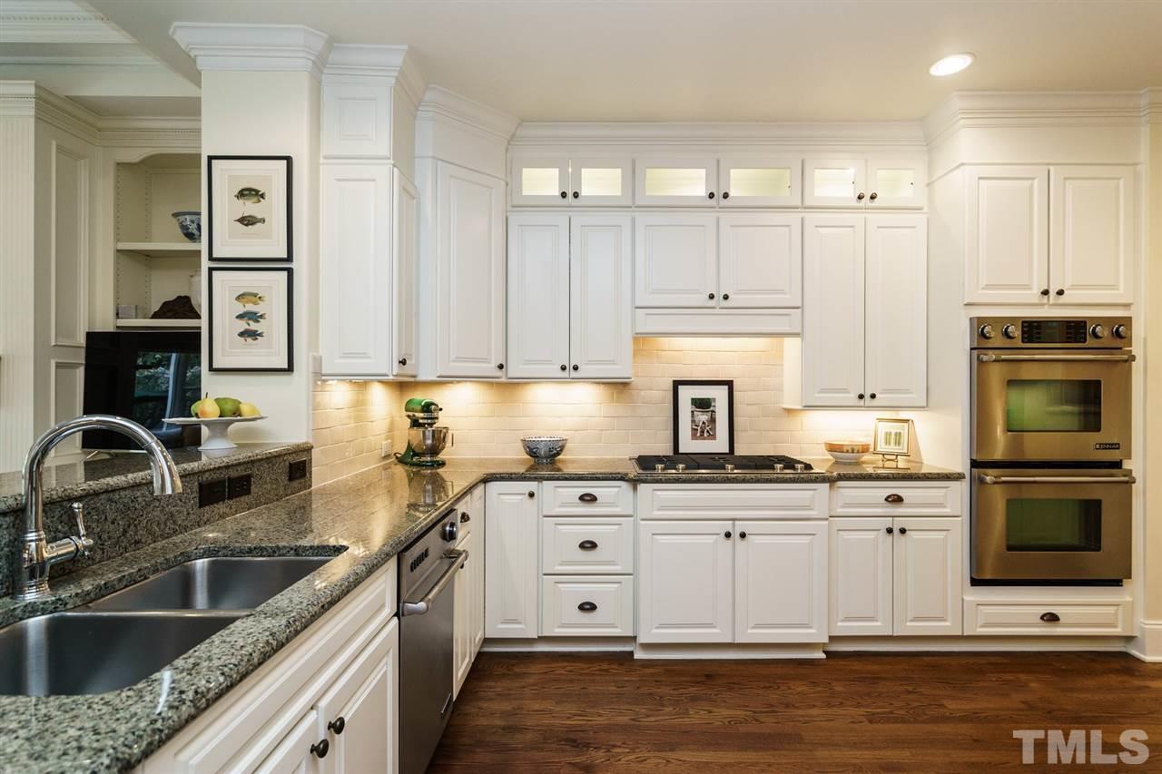 1820 Torrington Street Raleigh, NC 27615 - Photo 10 of 25 a kitchen with stainless steel appliances granite countertop a sink stove and refrigerator