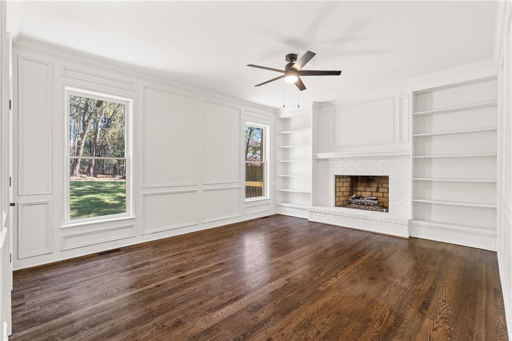 11125 Linbrook Lane Duluth, GA 30097 - Photo 14 of 51 a view of an empty room with wooden floor fireplace and a window