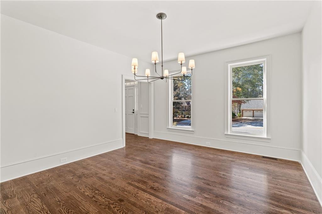 11125 Linbrook Lane Duluth, GA 30097 - Photo 18 of 51 an empty room with wooden floor exposed radiator and windows