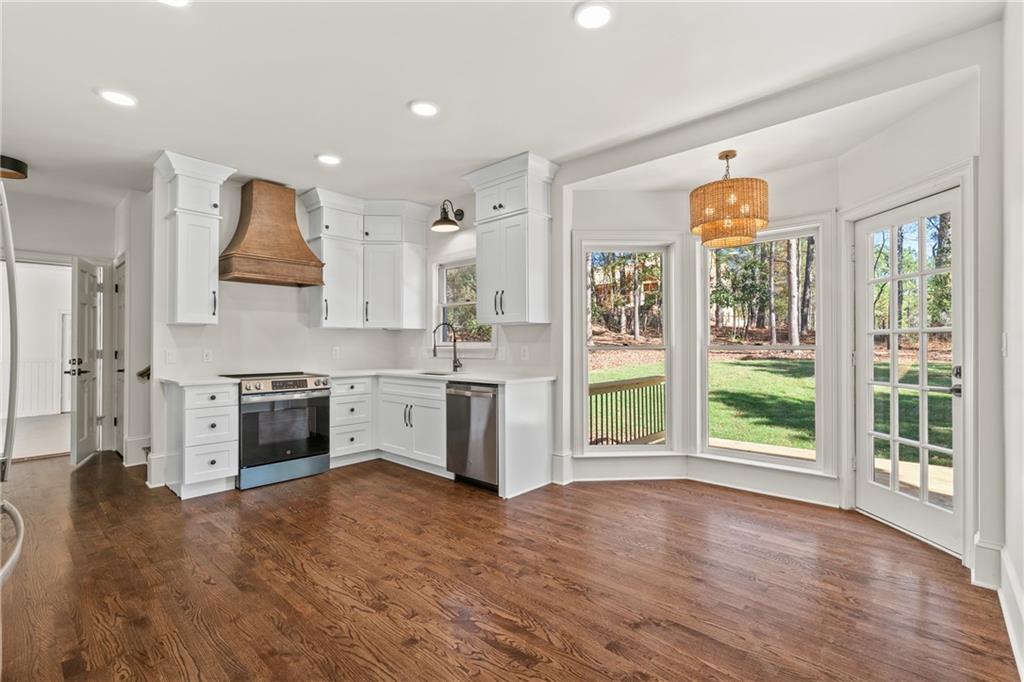 11125 Linbrook Lane Duluth, GA 30097 - Photo 20 of 51 a kitchen with stainless steel appliances a stove top oven and a refrigerator