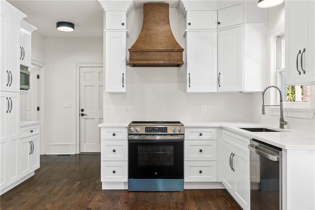 11125 Linbrook Lane Duluth, GA 30097 - Photo 22 of 51 a kitchen with white cabinets and white appliances