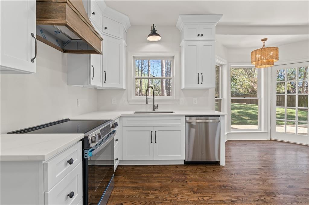 11125 Linbrook Lane Duluth, GA 30097 - Photo 24 of 51 a kitchen with stainless steel appliances granite countertop a sink and a stove