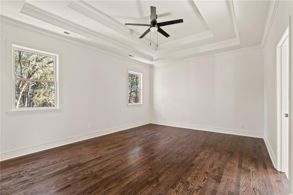 11125 Linbrook Lane Duluth, GA 30097 - Photo 31 of 51 an empty room with wooden floor ceiling fan and windows
