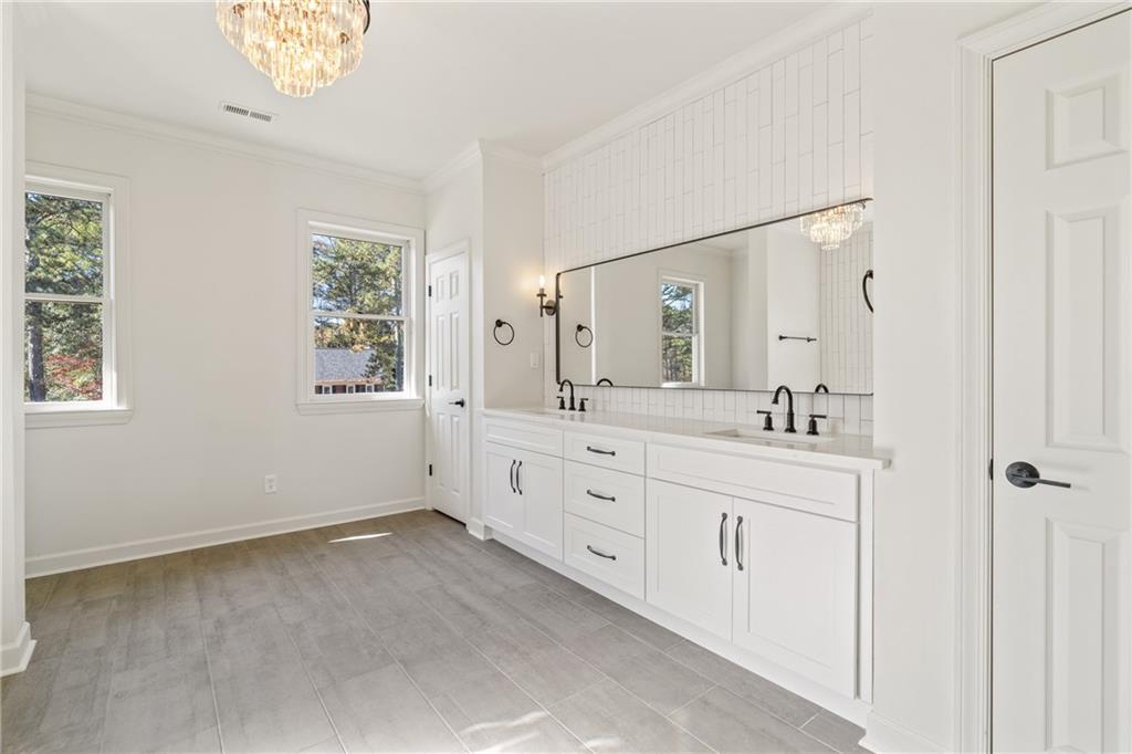 11125 Linbrook Lane Duluth, GA 30097 - Photo 33 of 51 a spacious bathroom with double sink large mirror and a window