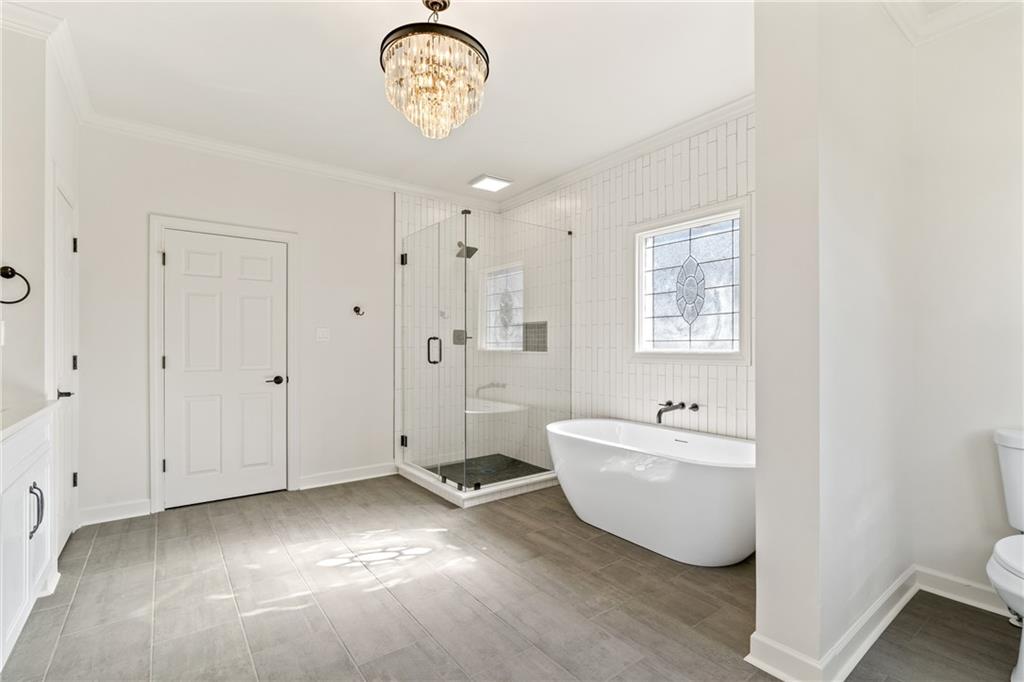 11125 Linbrook Lane Duluth, GA 30097 - Photo 34 of 51 a spacious bathroom with a bathtub and shower
