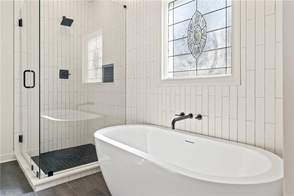 11125 Linbrook Lane Duluth, GA 30097 - Photo 36 of 51 a white bath tub sitting next to a shower
