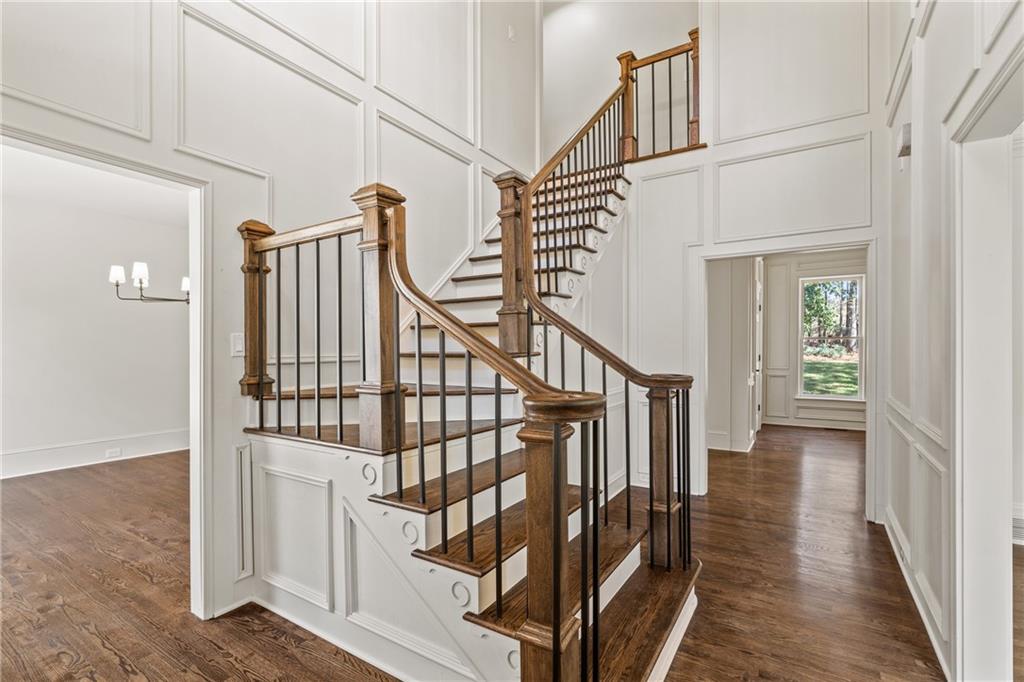 11125 Linbrook Lane Duluth, GA 30097 - Photo 8 of 51 a view of staircase with lots of frames on wall and wooden floor