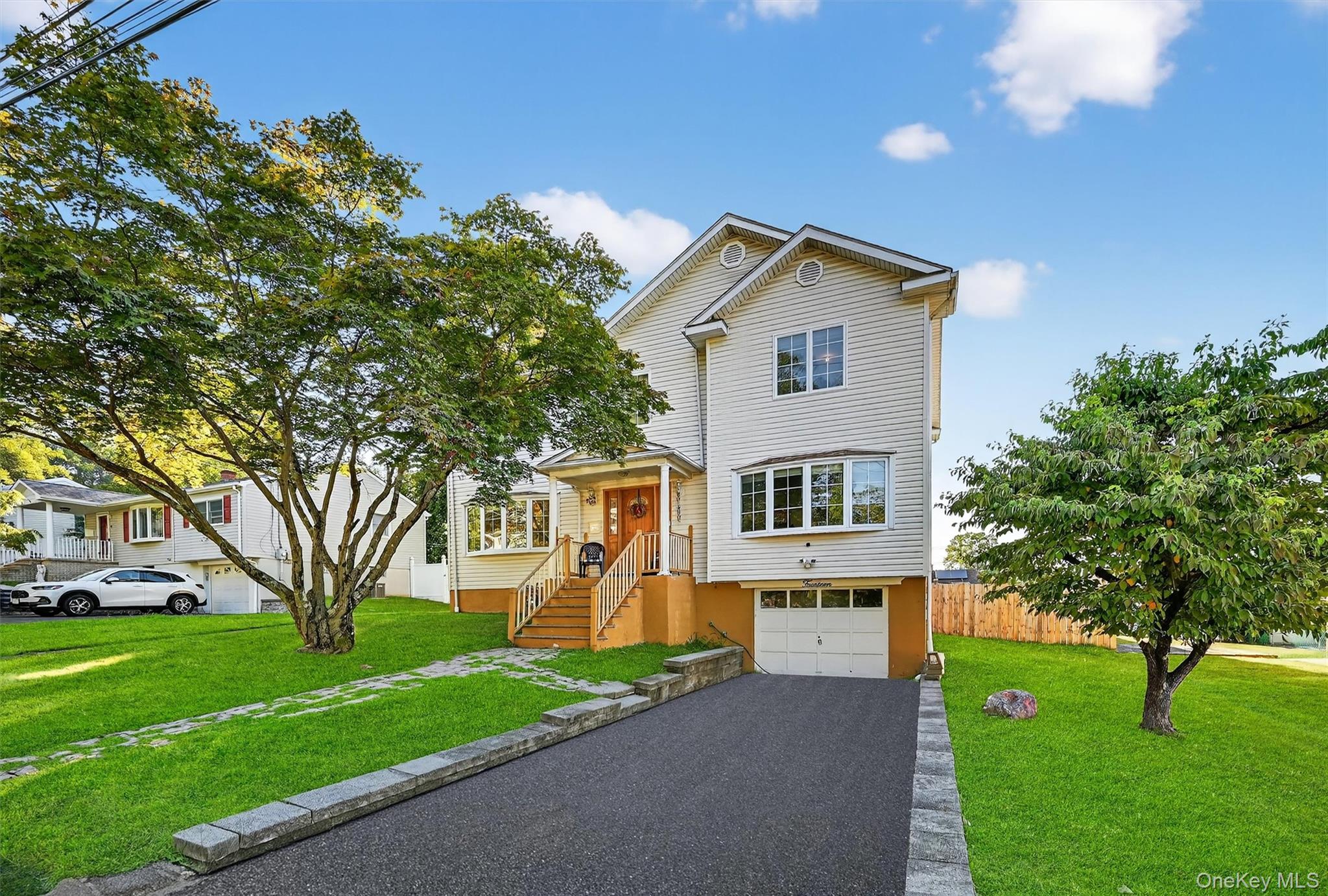 View of front facade with driveway and an attached garage