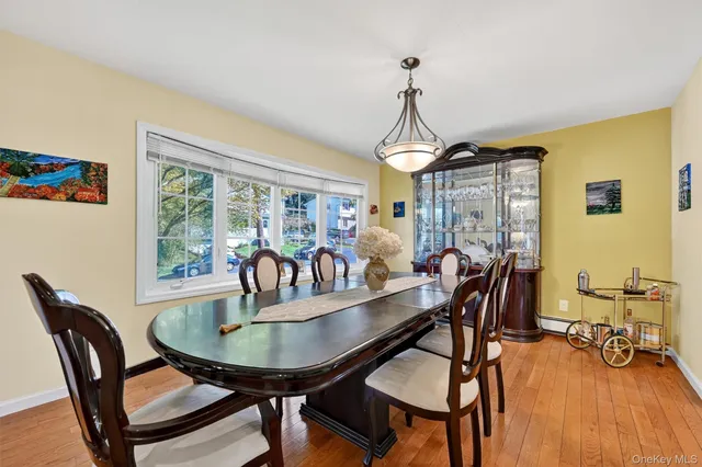 a dining room with furniture a chandelier and wooden floor