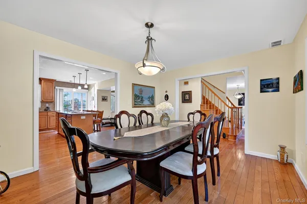 a dining room with furniture and wooden floor
