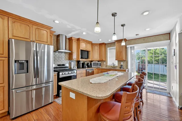 a kitchen with stainless steel appliances granite countertop a sink and stove