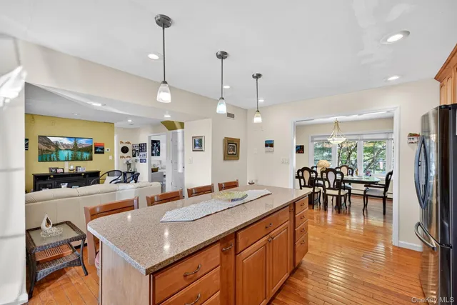 a kitchen with granite countertop a sink appliances and wooden floor