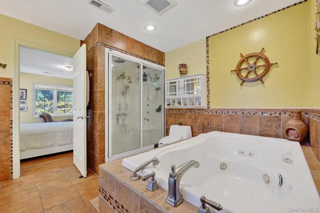 a spacious bathroom with a granite countertop sink and a mirror