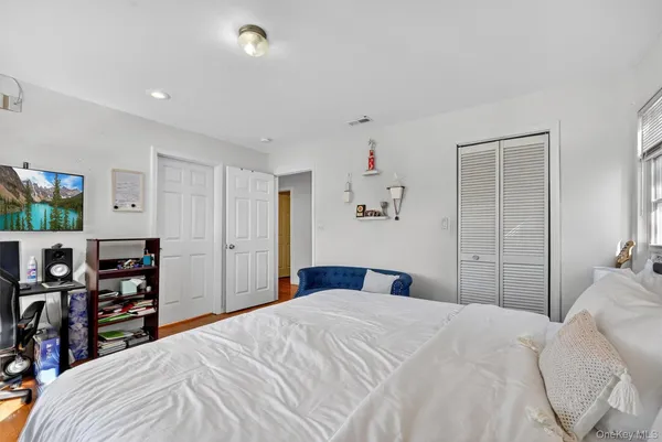 a bedroom with a large bed and a window
