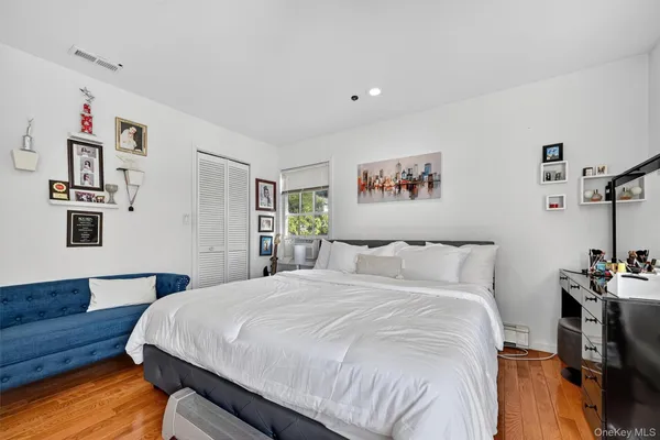 a bedroom with a bed and a book shelf