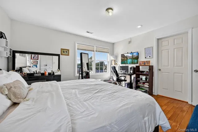 a bedroom with a bed and a book shelf