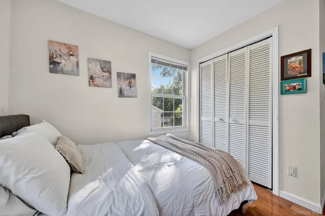 a bedroom with a bed and a large window
