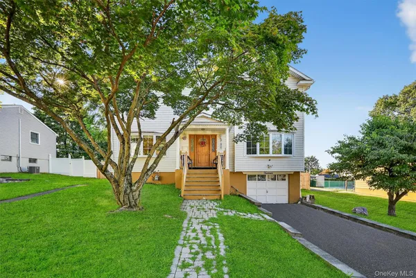 a front view of house with yard and green space