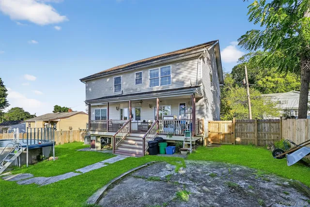 a view of a deck with couches table and chairs and potted plants