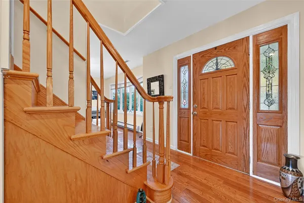 a view of an entryway with wooden floor and door