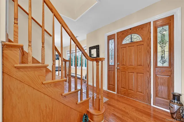 a view of an entryway with wooden floor and door