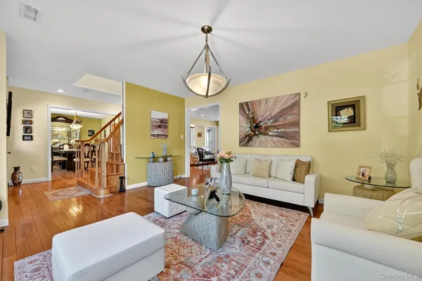 a living room with furniture a rug and white walls