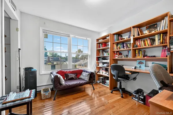a view of a livingroom with workspace and a window