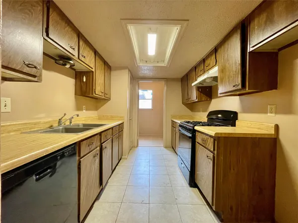 a kitchen with stainless steel appliances granite countertop a sink and stove