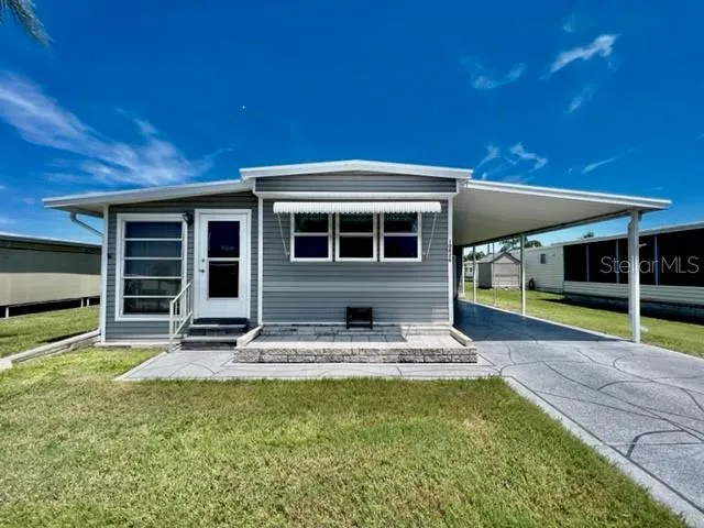 a view of the house with backyard porch and sitting area
