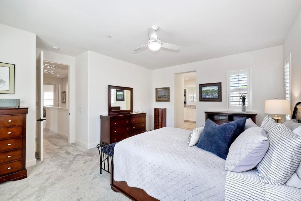 665 Gemstone Drive San Marcos, CA 92078 - Photo 16 of 49 a bedroom with a large bed and a dresser