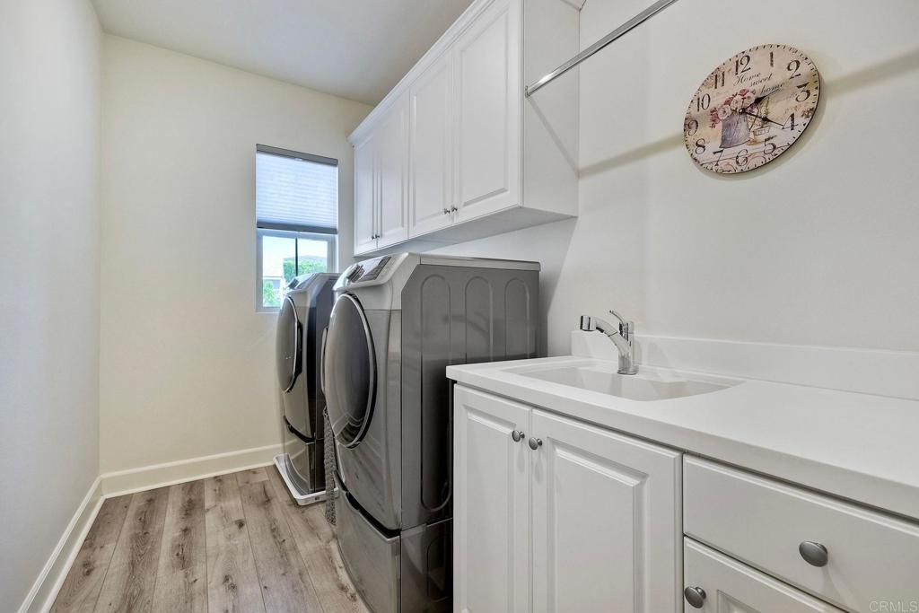 665 Gemstone Drive San Marcos, CA 92078 - Photo 23 of 49 a utility room with a sink and a mirror