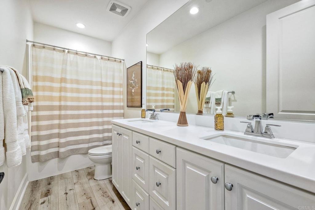 665 Gemstone Drive San Marcos, CA 92078 - Photo 24 of 49 a bathroom with a double vanity sink toilet and shower