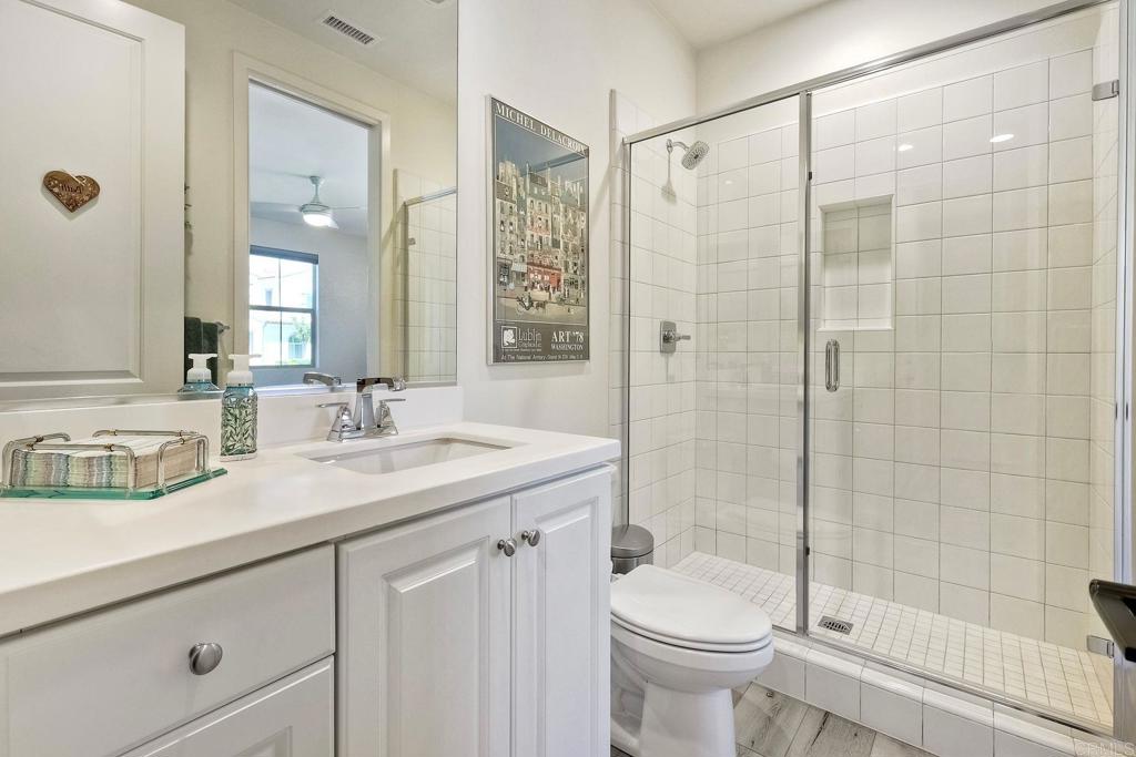 665 Gemstone Drive San Marcos, CA 92078 - Photo 28 of 49 a bathroom with a sink a toilet and shower