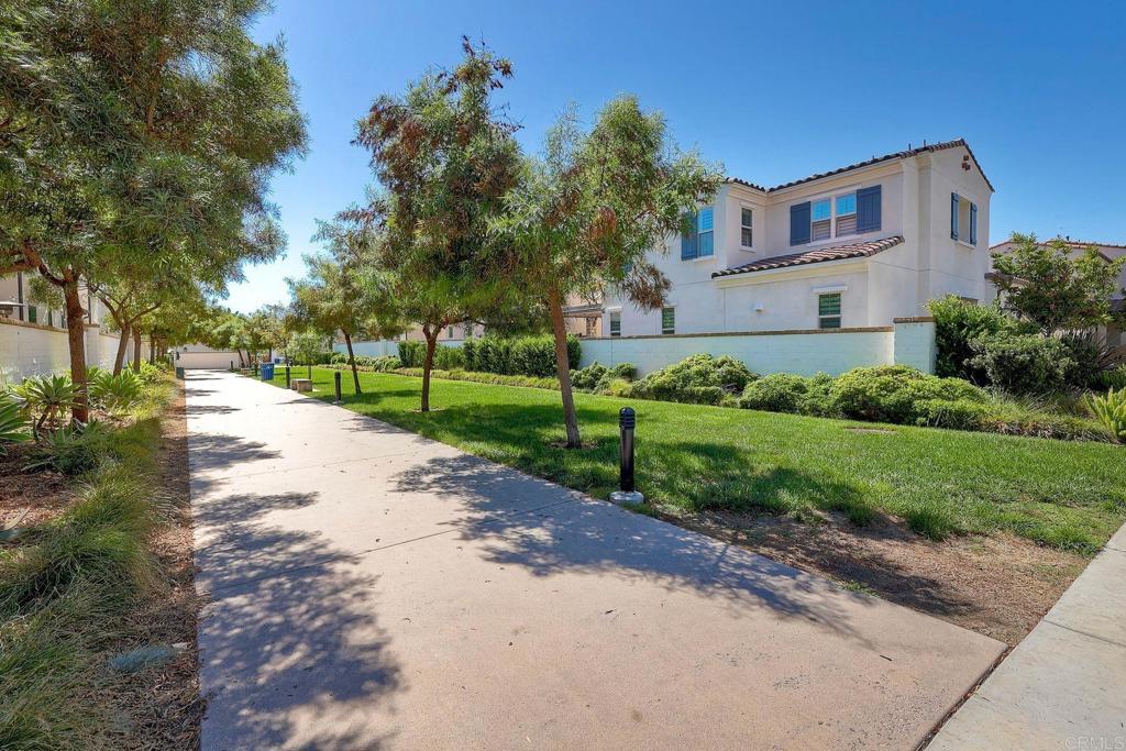 665 Gemstone Drive San Marcos, CA 92078 - Photo 37 of 49 a front view of a house with a yard and garage