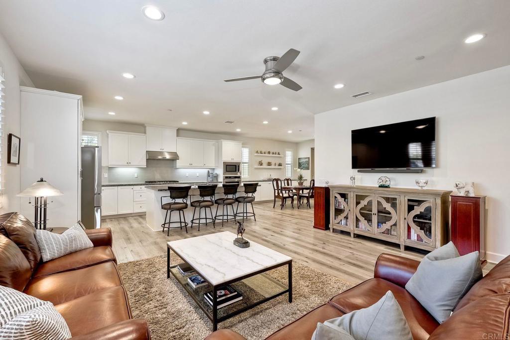 665 Gemstone Drive San Marcos, CA 92078 - Photo 5 of 49 a living room with furniture kitchen view and a flat screen tv