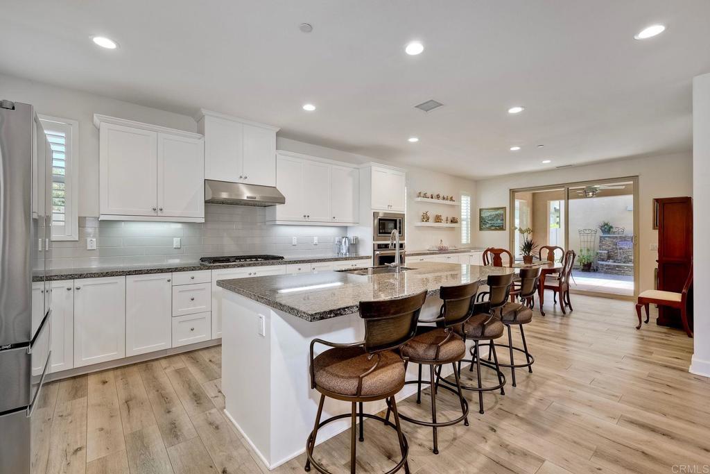 665 Gemstone Drive San Marcos, CA 92078 - Photo 6 of 49 a large kitchen with a table and chairs