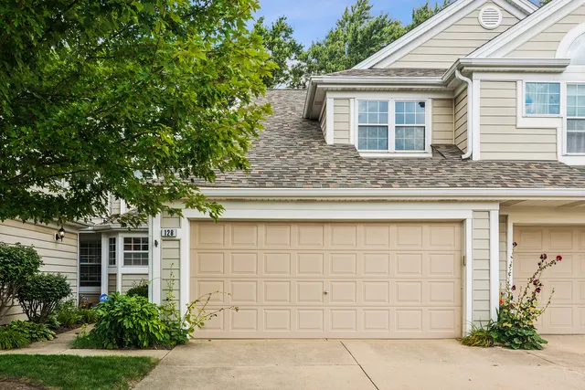 front view of a house with a tree
