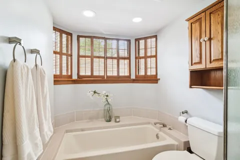 a bathroom with a bathtub and a window