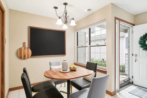 a view of a dining room with furniture wooden floor and chandelier