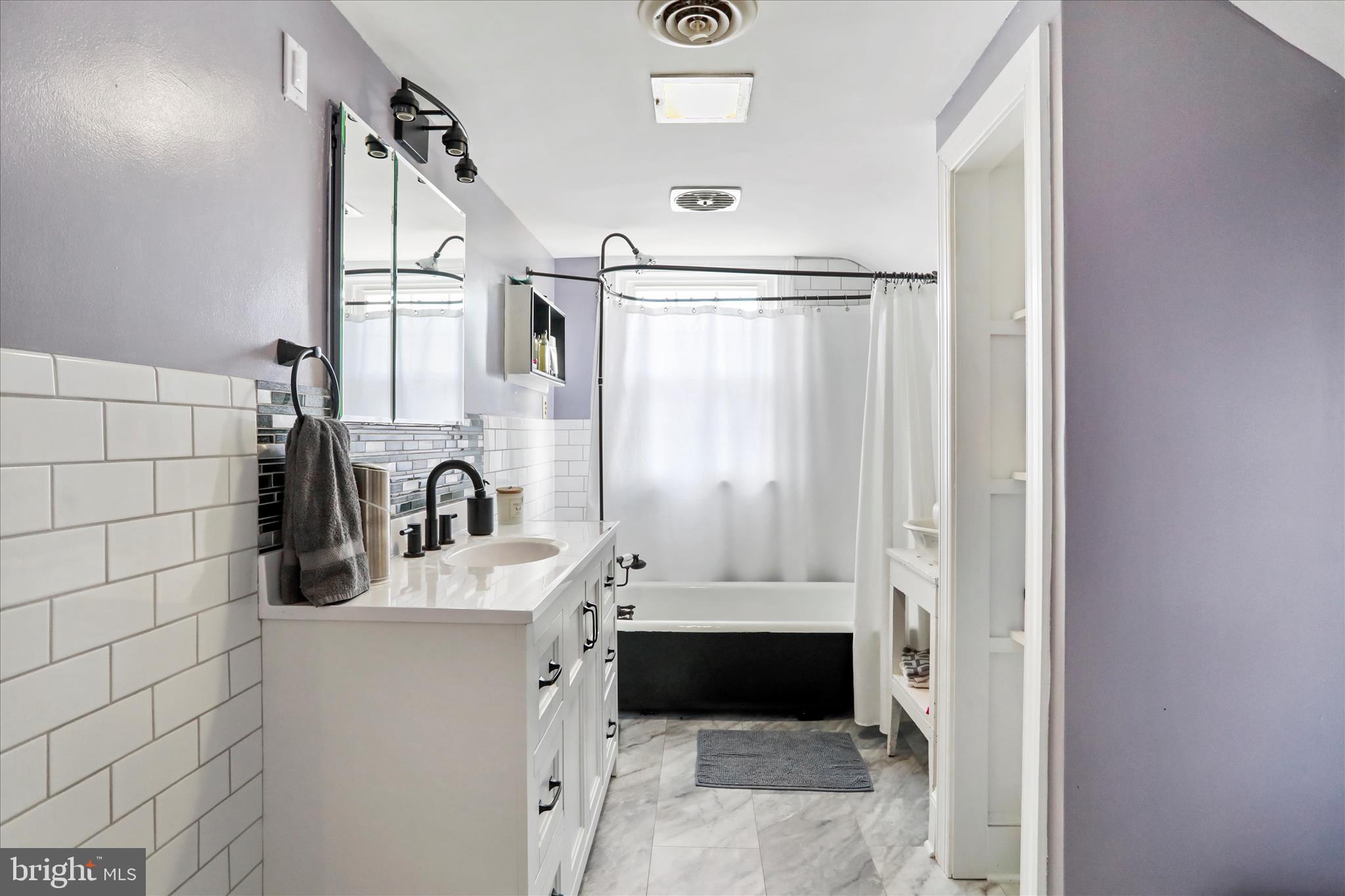 425 West 15th Street Front Royal, VA 22630 - Photo 25 of 47 a bathroom with a sink a mirror and shower
