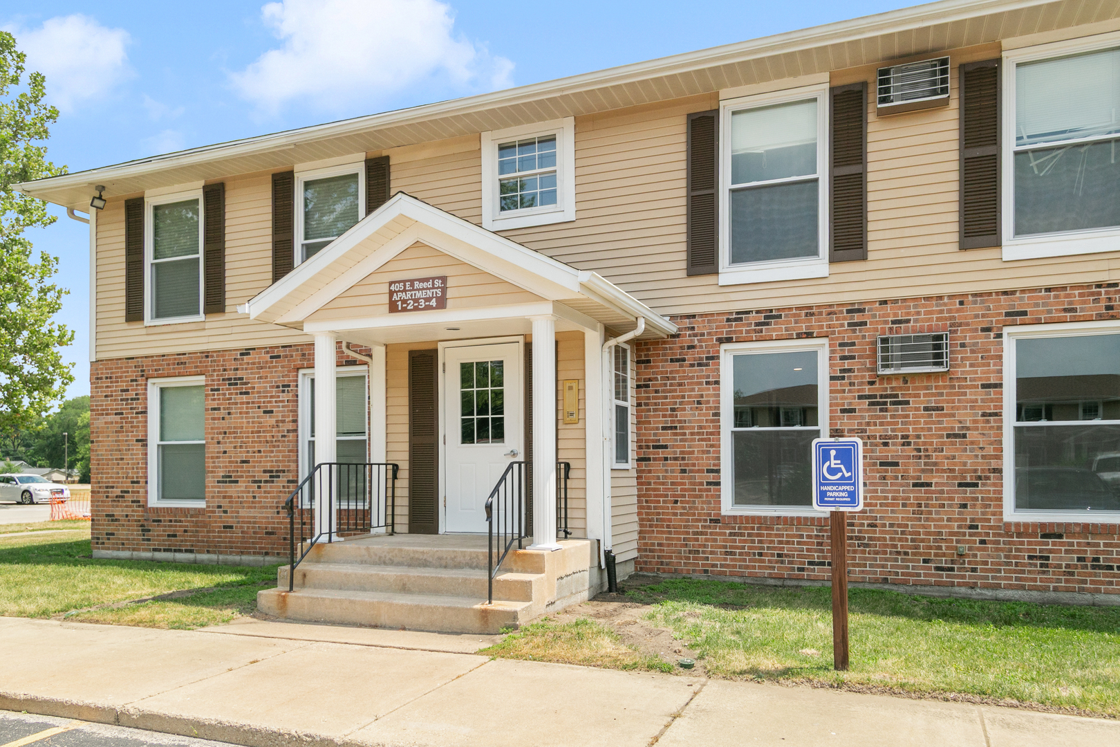 405 East Reed Street, Unit 9 Braidwood, IL 60408 - Photo 1 of 14 a front view of a house with a yard