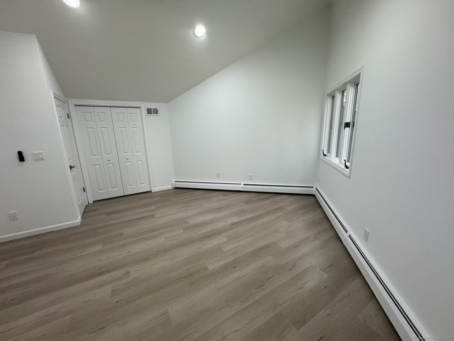 4 Earls Court, Unit C Farmington, CT 06032 - Photo 12 of 18 an empty room with wooden floor and windows