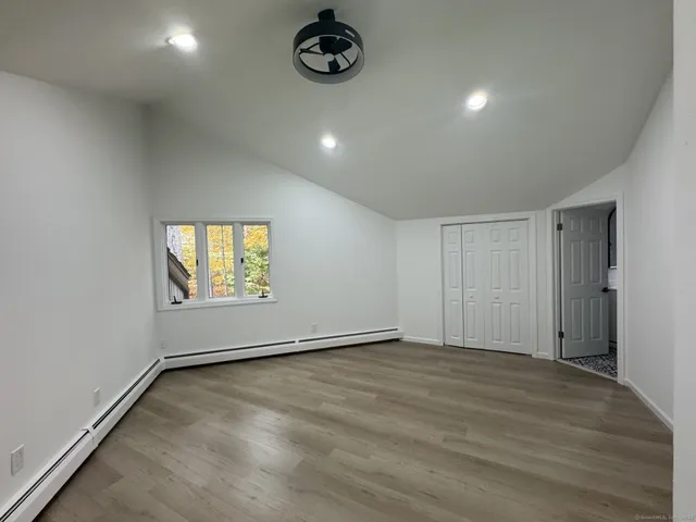 an empty room with a empty space and windows