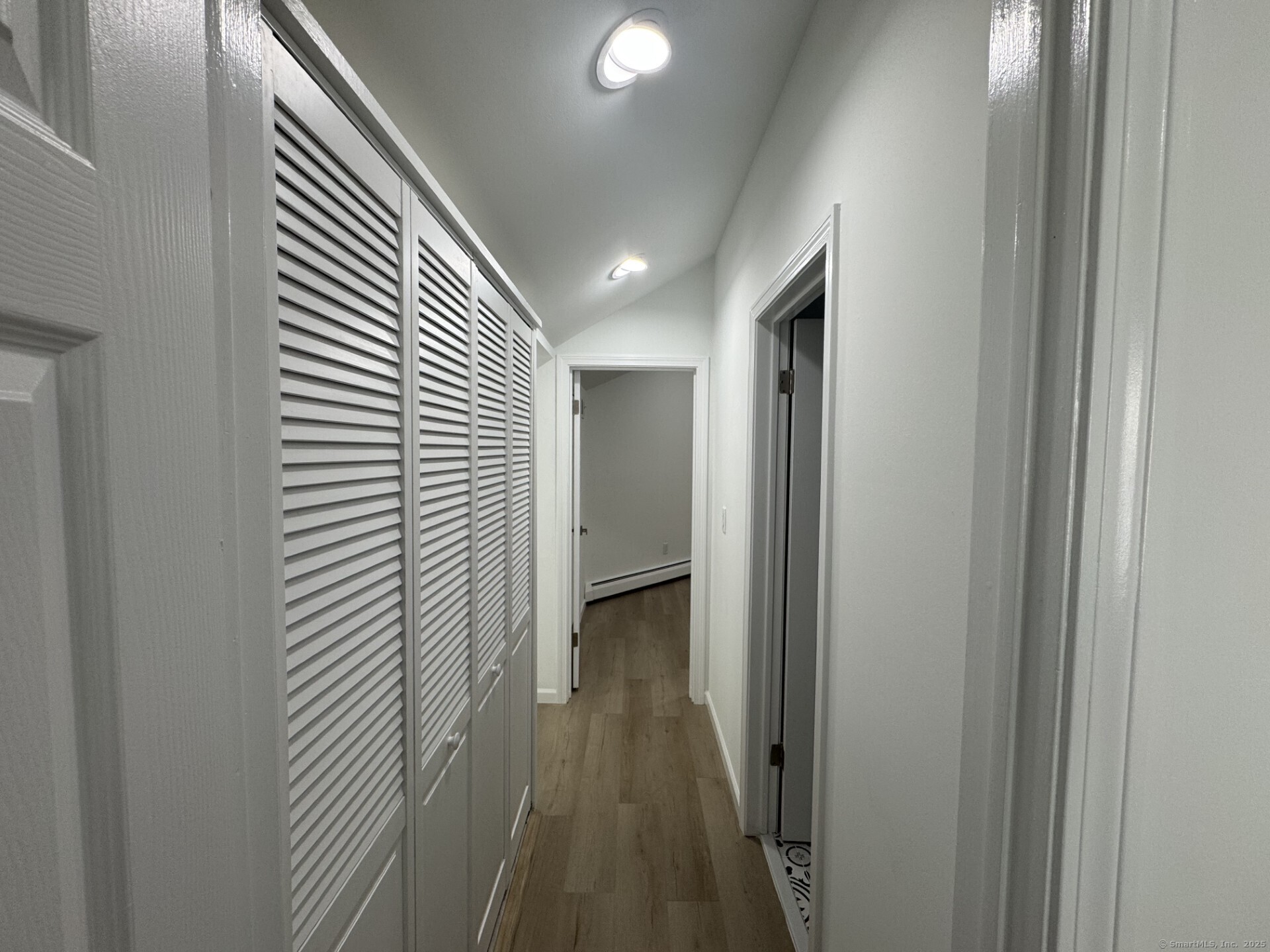 4 Earls Court, Unit C Farmington, CT 06032 - Photo 15 of 18 a view of a hallway with wooden floor and staircase