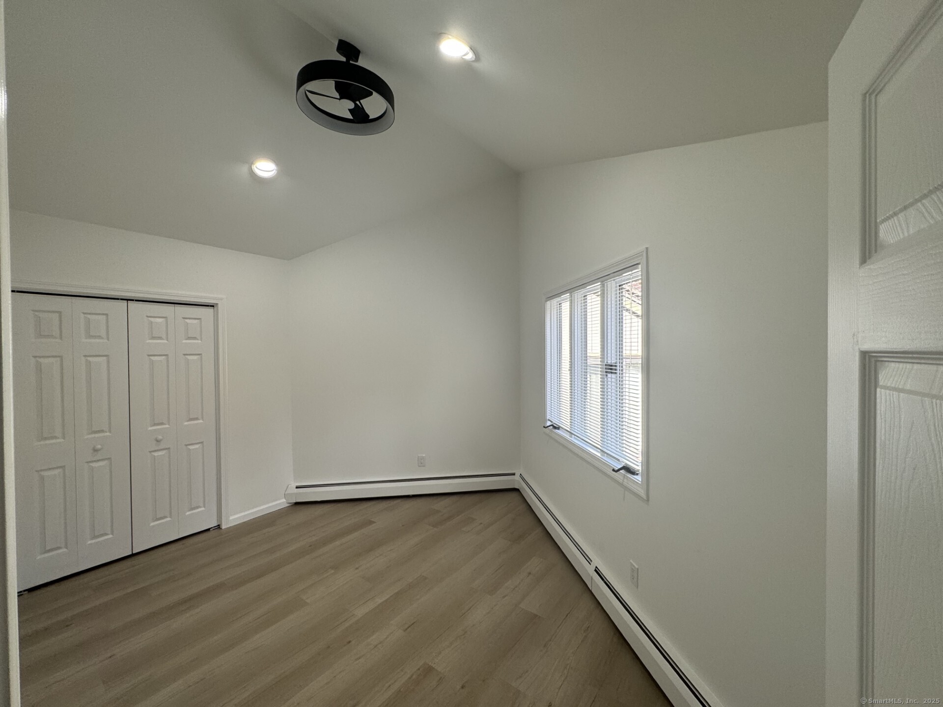4 Earls Court, Unit C Farmington, CT 06032 - Photo 16 of 18 an empty room with wooden floor and windows