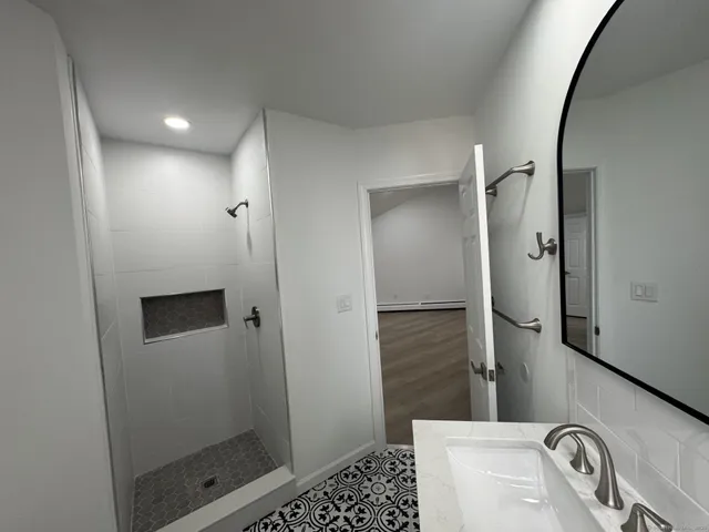a bathroom with a shower and a sink