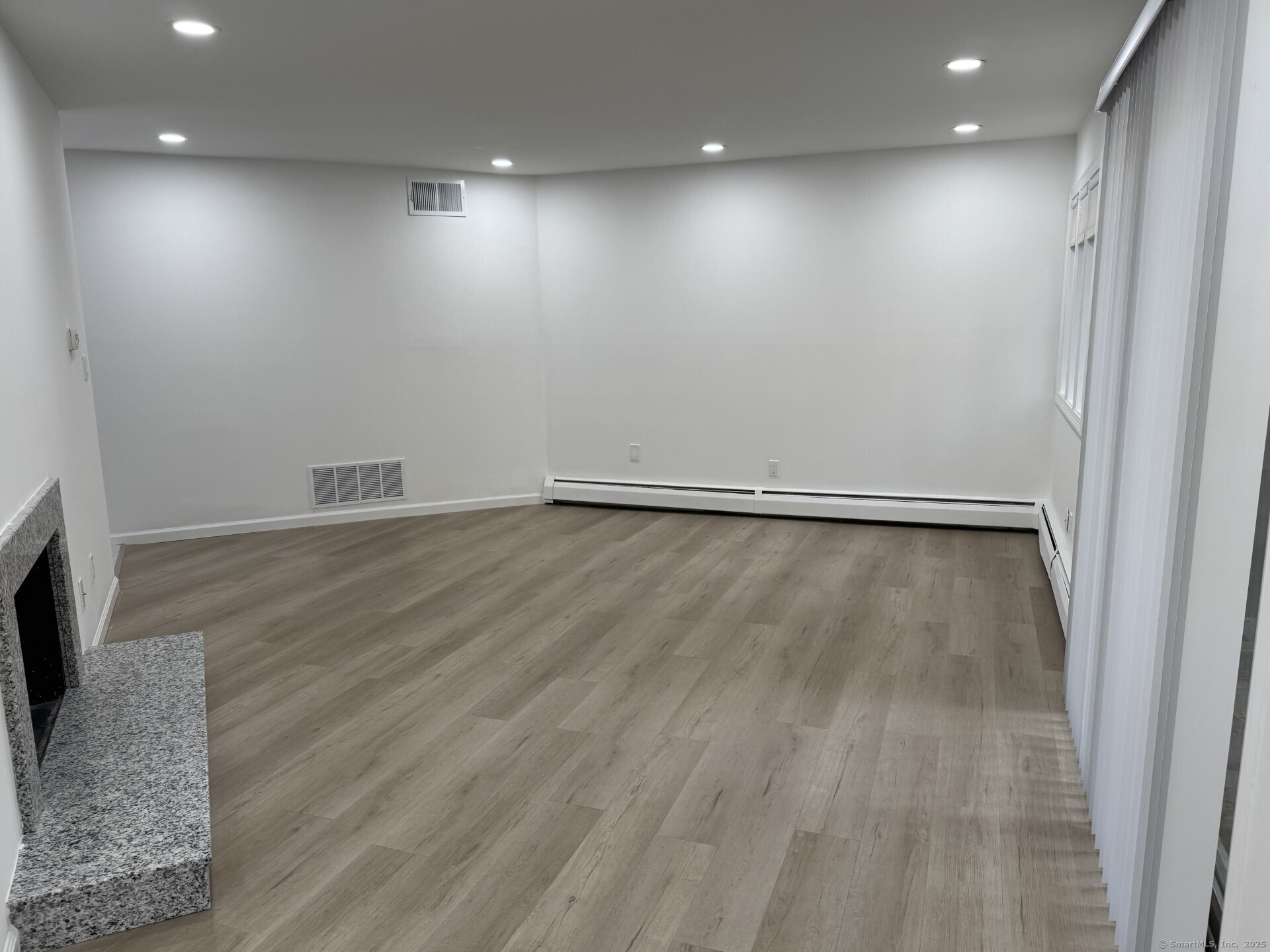4 Earls Court, Unit C Farmington, CT 06032 - Photo 7 of 18 an empty room with wooden floor and a window