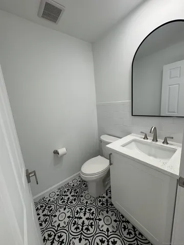 a bathroom with a sink toilet and vanity